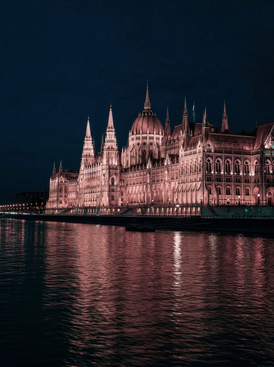 Hungarian Parliament building at night, reflected in the Danube