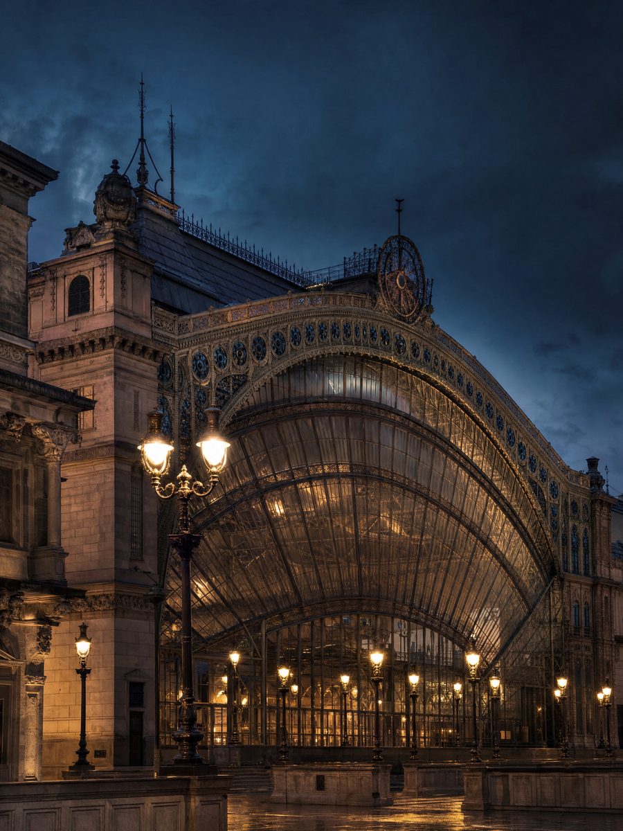 Budapest Keleti railway station, 19th-century iron-and-glass hall, at dusk